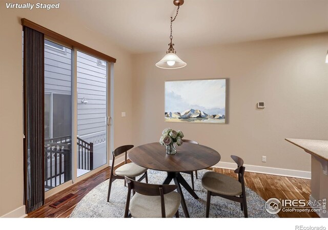 8482 Parkland St, Broomfield, CO 80021 - dining room featuring baseboards and wood finished floors