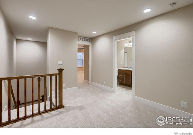 8482 Parkland St, Broomfield, CO 80021 - hallway featuring an upstairs landing, light carpet, recessed lighting, and baseboards