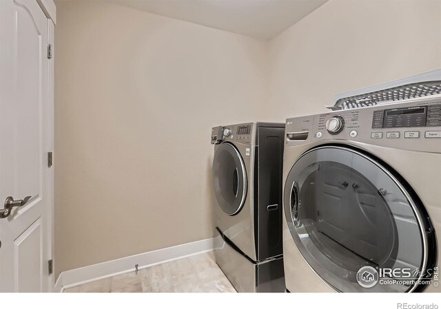 8482 Parkland St, Broomfield, CO 80021 - clothes washing area featuring washer and clothes dryer and baseboards