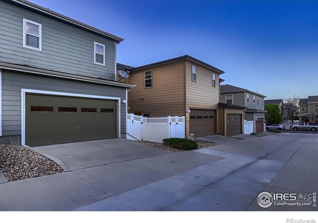 8482 Parkland St, Broomfield, CO 80021 - view of home's exterior with a garage, fence, driveway, and a residential view