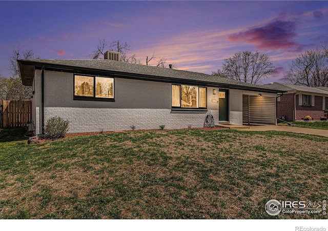 2566 S Stuart St, Denver, CO 80219 - ranch-style house featuring brick siding, an attached garage, and concrete driveway