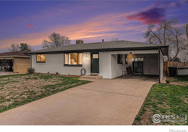 2566 S Stuart St, Denver, CO 80219 - single story home featuring concrete driveway, brick siding, and roof with shingles