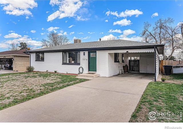 2566 S Stuart St, Denver, CO 80219 - ranch-style house featuring concrete driveway, brick siding, and an attached carport