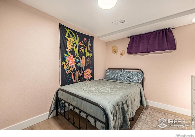 2566 S Stuart St, Denver, CO 80219 - bedroom featuring wood finished floors and baseboards