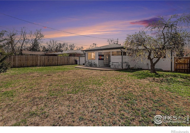 2566 S Stuart St, Denver, CO 80219 - yard at dusk featuring a patio