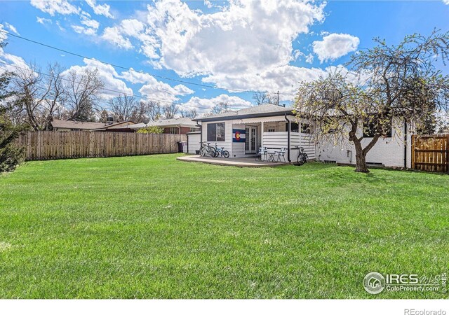 2566 S Stuart St, Denver, CO 80219 - fenced backyard with a patio area