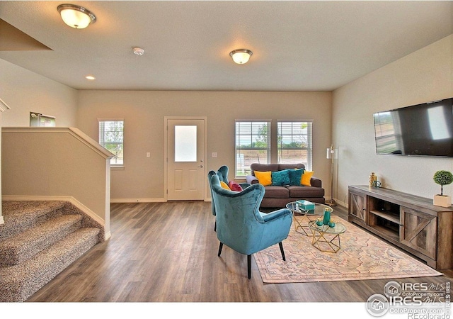 1693 Grand Ave Unit 1, Windsor, CO 80550 - living area featuring wood finished floors, stairway, baseboards, and healthy amount of natural light