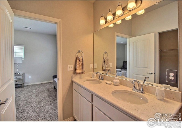 1693 Grand Ave Unit 1, Windsor, CO 80550 - bathroom with double vanity, ensuite bath, and baseboards