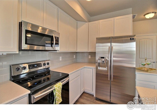 1693 Grand Ave Unit 1, Windsor, CO 80550 - kitchen with stainless steel appliances, white cabinetry, light countertops, and backsplash