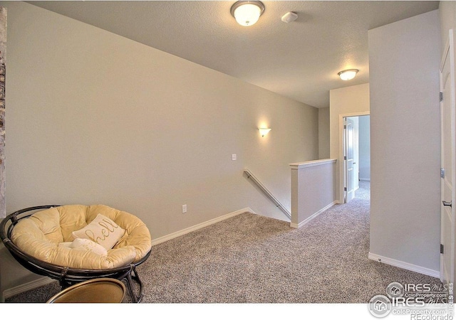 1693 Grand Ave Unit 1, Windsor, CO 80550 - living area with an upstairs landing, carpet flooring, and baseboards
