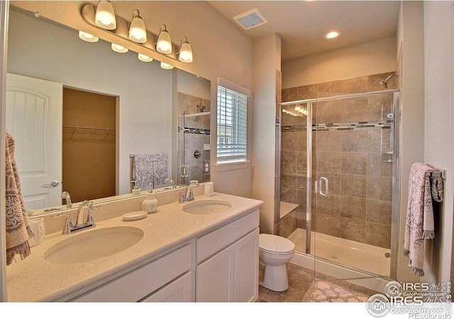 1693 Grand Ave Unit 1, Windsor, CO 80550 - full bath with a stall shower, tile patterned flooring, double vanity, toilet, and a walk in closet
