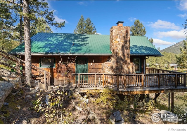 741 Hickory Dr, Lyons, CO 80540 - back of house featuring a deck with mountain view, a chimney, and metal roof