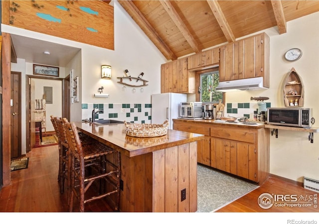 741 Hickory Dr, Lyons, CO 80540 - kitchen featuring a sink, vaulted ceiling with beams, white appliances, wood ceiling, and under cabinet range hood