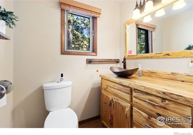 741 Hickory Dr, Lyons, CO 80540 - bathroom with a wealth of natural light, toilet, vanity, and baseboards