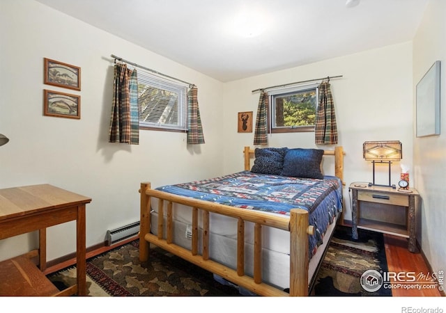 741 Hickory Dr, Lyons, CO 80540 - bedroom with a baseboard radiator and wood finished floors