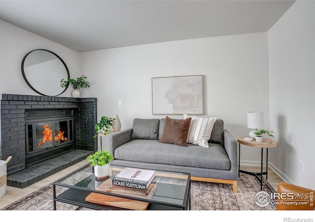 3200 Azalea Dr Unit 5, Fort Collins, CO 80526 - living area featuring a brick fireplace, wood finished floors, and baseboards