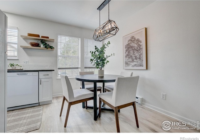 3200 Azalea Dr Unit 5, Fort Collins, CO 80526 - dining space featuring light wood-type flooring, a chandelier, and baseboards