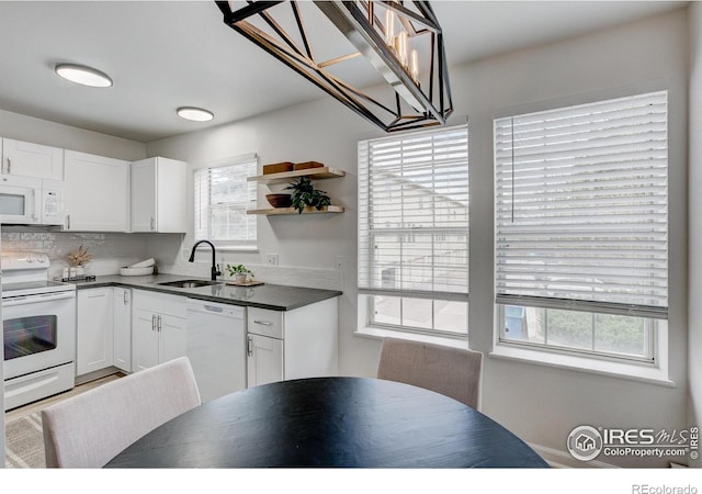 3200 Azalea Dr Unit 5, Fort Collins, CO 80526 - kitchen featuring white appliances, a sink, dark countertops, white cabinets, and decorative backsplash