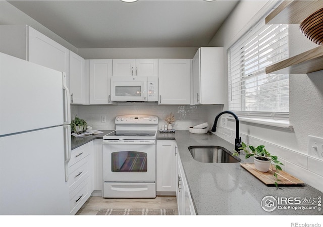 3200 Azalea Dr Unit 5, Fort Collins, CO 80526 - kitchen with white appliances, a sink, backsplash, and white cabinetry