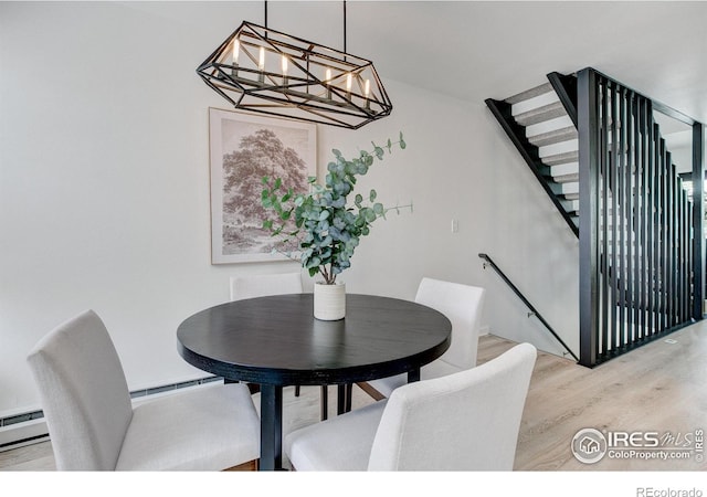 3200 Azalea Dr Unit 5, Fort Collins, CO 80526 - dining space with light wood finished floors, baseboard heating, a chandelier, and stairs
