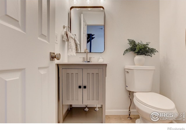 3200 Azalea Dr Unit 5, Fort Collins, CO 80526 - bathroom with toilet, vanity, baseboards, and wood finished floors