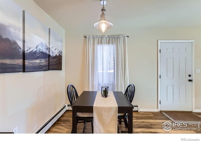 695 Manhattan Dr Unit 22, Boulder, CO 80303 - dining room with a baseboard heating unit, a baseboard radiator, baseboards, and wood finished floors