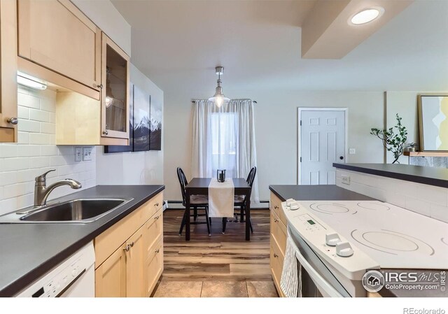 695 Manhattan Dr Unit 22, Boulder, CO 80303 - kitchen with dark countertops, a sink, a baseboard heating unit, white appliances, and glass insert cabinets