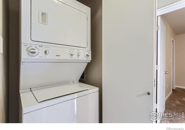 695 Manhattan Dr Unit 22, Boulder, CO 80303 - laundry room featuring baseboards, carpet flooring, stacked washing maching and dryer, and laundry area
