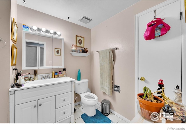 bathroom with visible vents, toilet, vanity, and tile patterned floors
