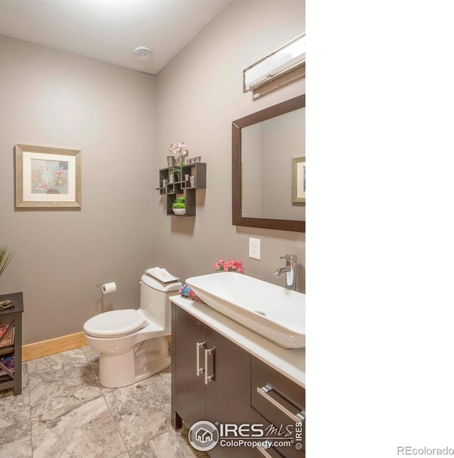 91 Eagle Rising Pl, Livermore, CO 80536 - bathroom featuring vanity, toilet, and marble look tile flooring