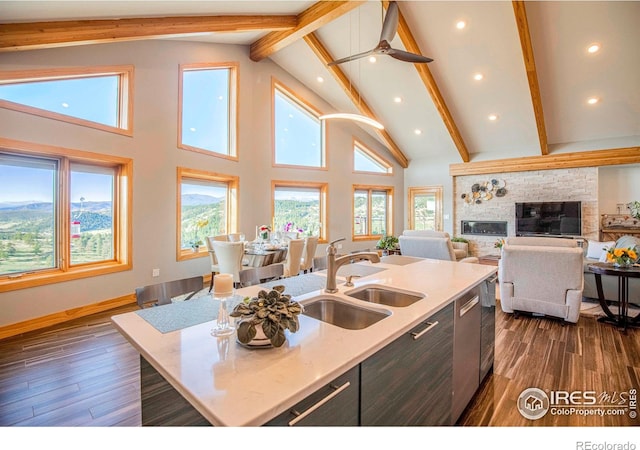 91 Eagle Rising Pl, Livermore, CO 80536 - kitchen with a sink, beamed ceiling, an island with sink, dark wood-style flooring, and recessed lighting
