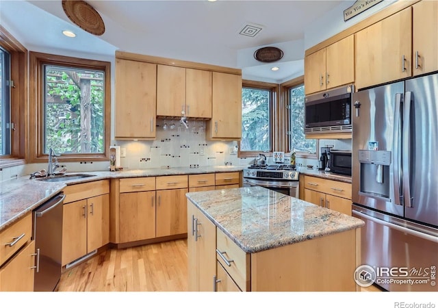 36 High View Dr, Boulder, CO 80304 - kitchen with appliances with stainless steel finishes, a sink, light brown cabinetry, light wood finished floors, and light stone countertops