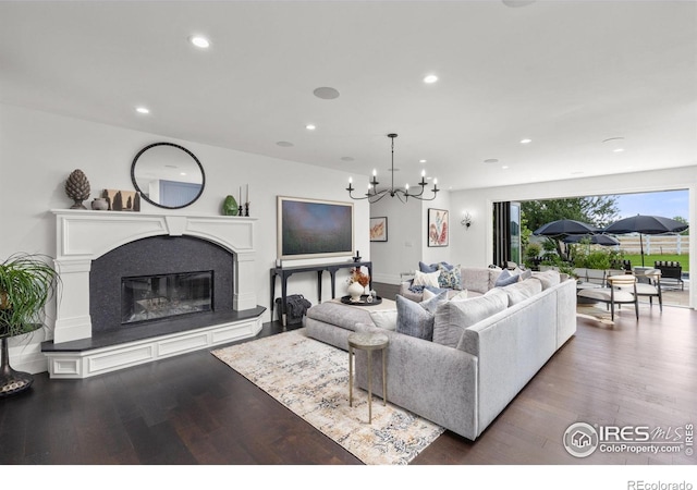 living room with wood finished floors, a chandelier, recessed lighting, and a fireplace