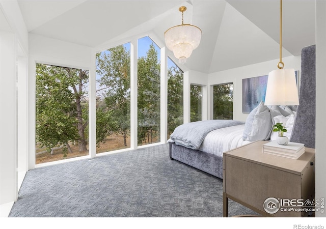 carpeted bedroom with a chandelier and lofted ceiling