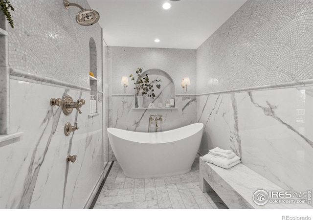 bathroom featuring tile walls, a freestanding tub, recessed lighting, wallpapered walls, and a marble finish shower