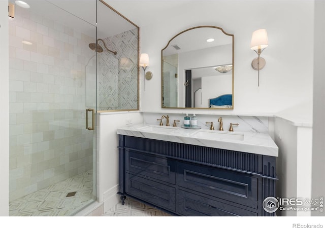 bathroom featuring a shower stall, double vanity, and recessed lighting