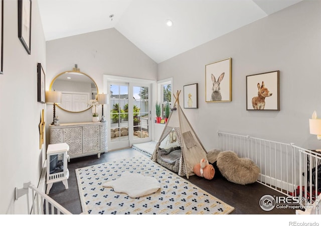 bedroom featuring heating unit, access to exterior, and high vaulted ceiling