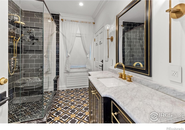 bathroom featuring ornamental molding, a stall shower, and vanity