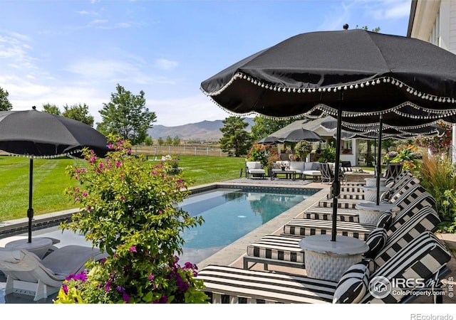 view of swimming pool featuring a patio, a mountain view, and outdoor lounge area