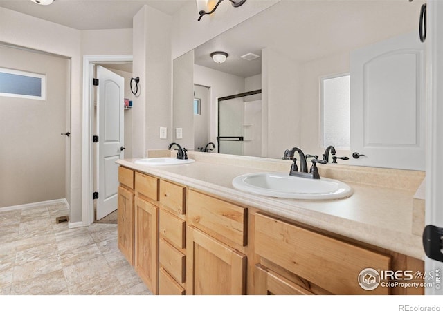 full bathroom featuring double vanity, visible vents, a sink, and a stall shower