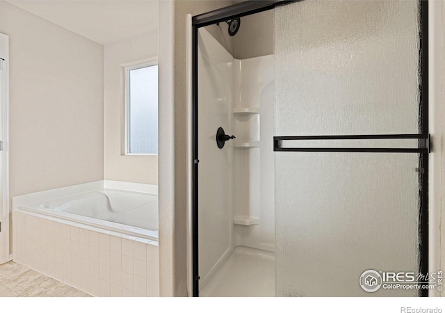 bathroom with a garden tub and a stall shower