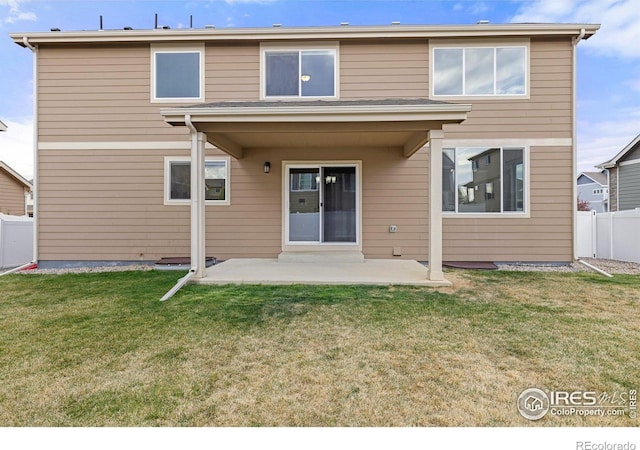 back of property featuring a patio area, fence, and a yard