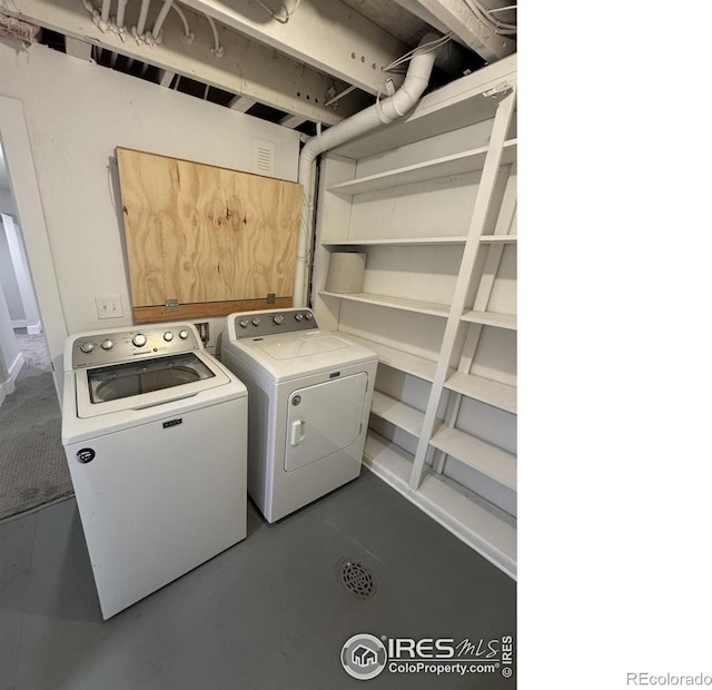 clothes washing area with independent washer and dryer, laundry area, and visible vents