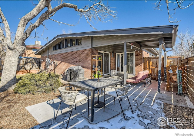 view of patio / terrace with a fenced backyard, a grill, and outdoor dining space