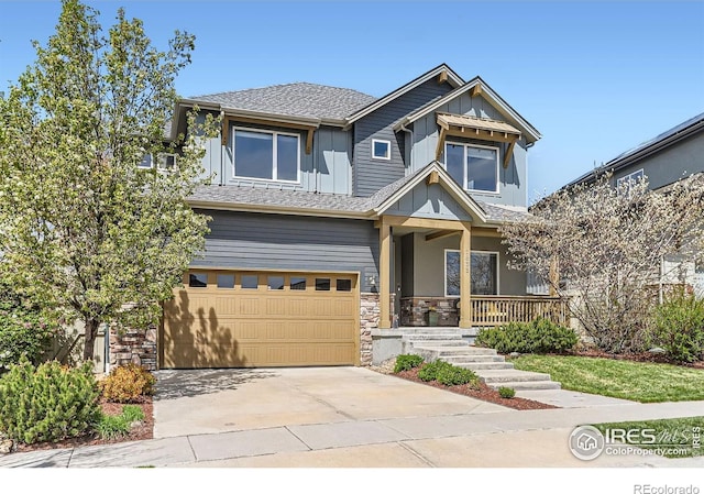 craftsman inspired home featuring board and batten siding, driveway, covered porch, stone siding, and a garage