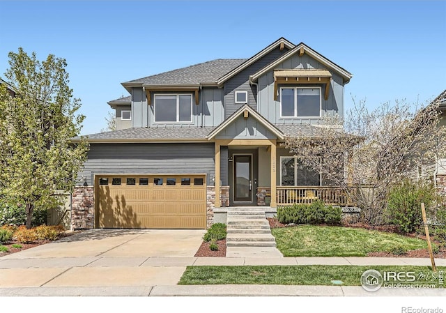 craftsman-style house with driveway, stone siding, covered porch, an attached garage, and board and batten siding