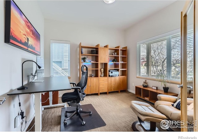 home office featuring plenty of natural light and light colored carpet