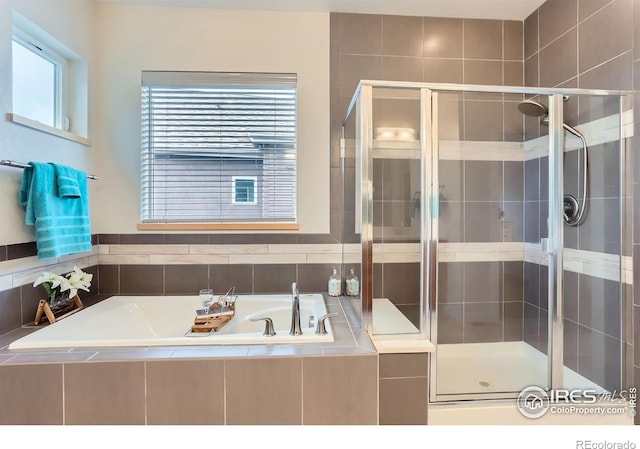 bathroom with a garden tub and a stall shower