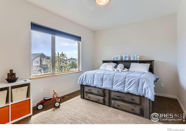 carpeted bedroom featuring visible vents and baseboards