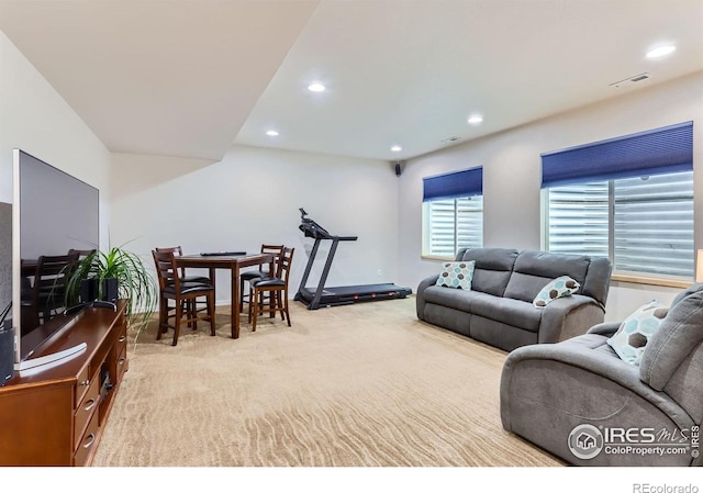living area featuring visible vents, carpet, and recessed lighting